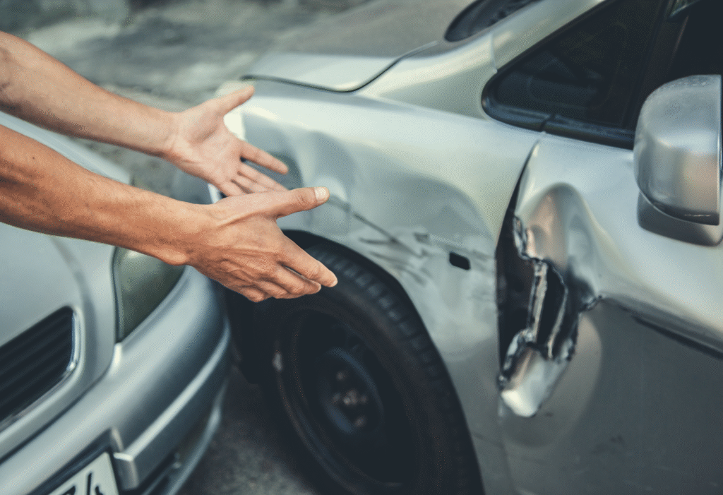 Side collision damage on silver car