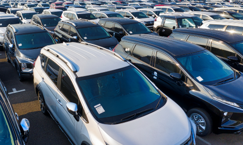 Large vehicle inventory lot filled with parked cars