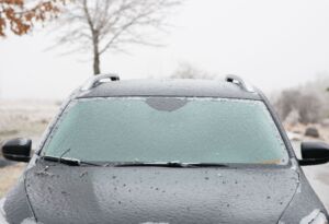 Ice-covered car windshield after a winter storm.