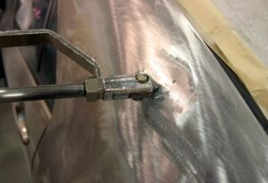 Auto body dent repair tool working on car panel