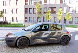 Damaged car with large dents on side doors