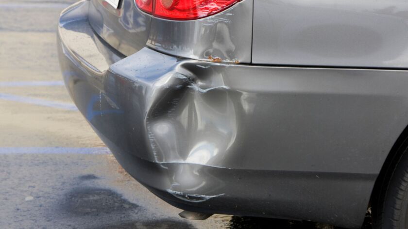 Gray car rear bumper with collision damage