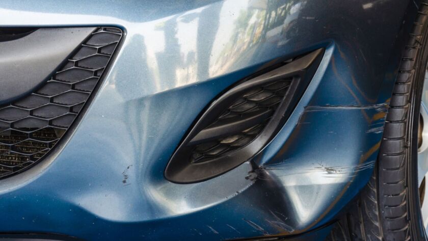 Blue car front bumper with scratches and dent damage