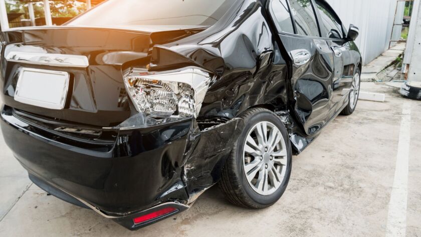 Black car with rear-side collision damage